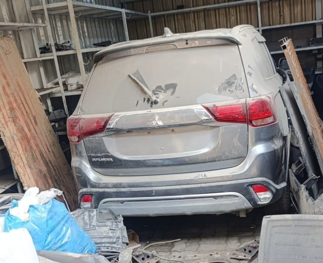 Grey Mitsubishi Outlander SUV rear halfcut — tailgate, tail lights and rear bumper, Sharjah market