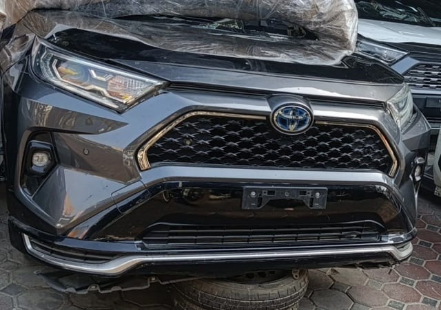Dark grey Toyota RAV4 SUV front cut — bumper, grille, headlights and fog lamps, Sharjah market