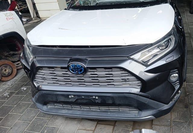 Dark grey Toyota RAV4 SUV front cut — white hood, bumper, grille and headlights, Sharjah market