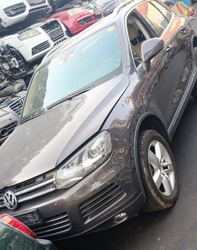 Dark brown Volkswagen Touareg SUV front — bumper, grille, headlights and hood, Sharjah market