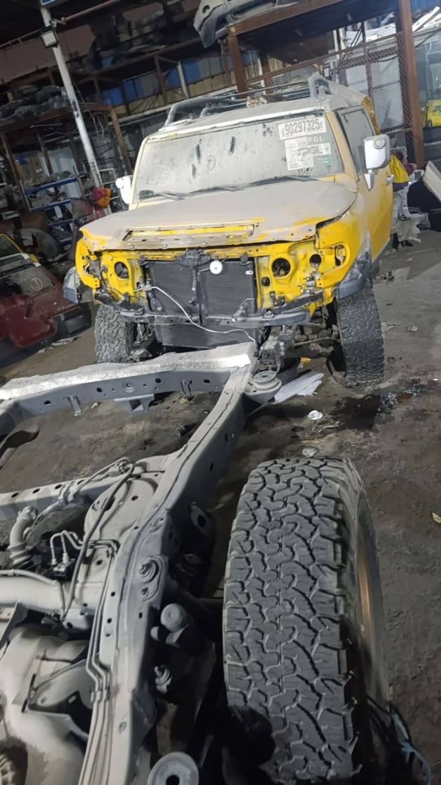 Yellow Toyota FJ Cruiser SUV halfcut — hood, fenders, radiator support and exposed chassis, Sharjah market