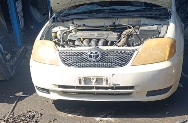 White Toyota Corolla sedan front halfcut — bumper, grille, headlights and engine bay, Sharjah market