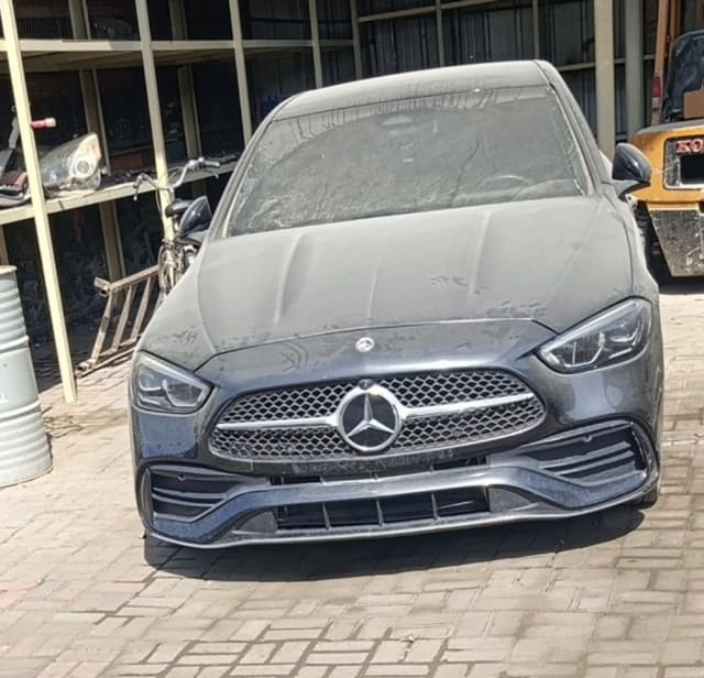 Dark grey Mercedes-Benz C-Class sedan front — bumper, grille, star emblem and headlights, Sharjah market