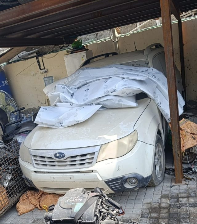White Subaru Forester SUV front end for parts — bumper, grille, headlights and hood, Sharjah market