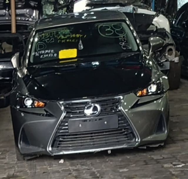 Dark grey Lexus IS sedan front halfcut — spindle grille, hood, bumper and headlights, Sharjah market