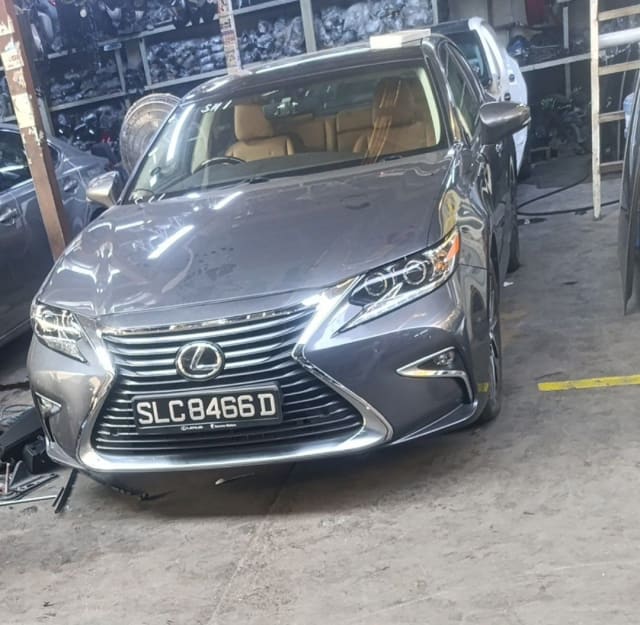 Dark grey Lexus ES sedan halfcut front — grille, headlights, bumper and hood, Sharjah market
