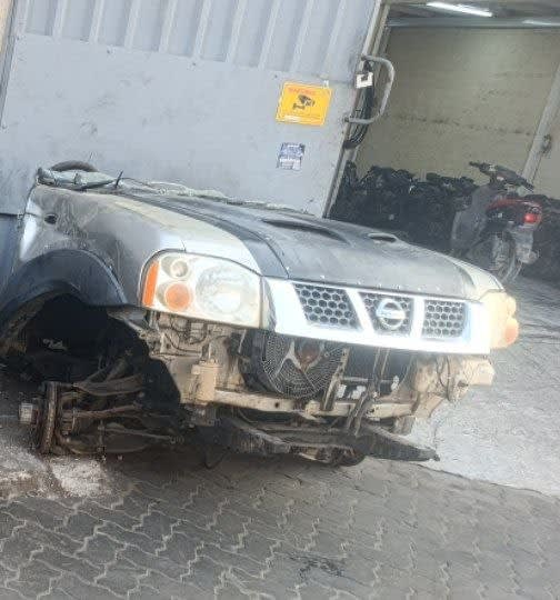 Silver Nissan Navara front halfcut — grille, headlights, hood and fenders, Sharjah market