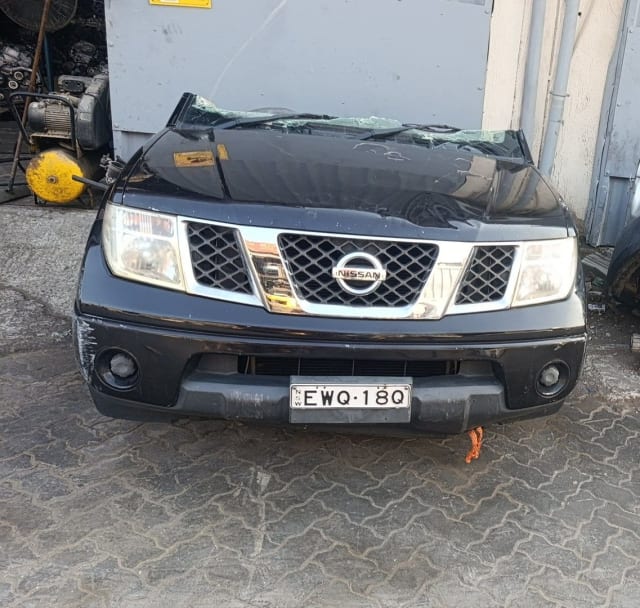 Black Nissan Navara pickup front halfcut — bumper, chrome grille and headlights, Sharjah market