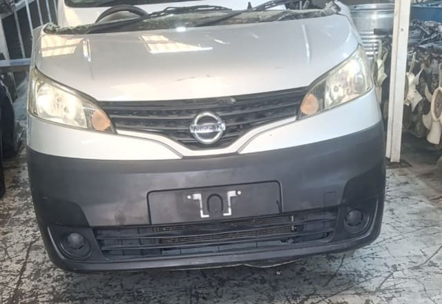 Silver Nissan NV200 van front halfcut — bumper, chrome grille, headlights and hood, Sharjah market