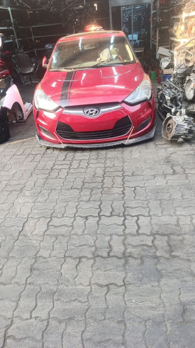 Red Hyundai Veloster front halfcut — bumper, grille, headlights and hood, Sharjah market