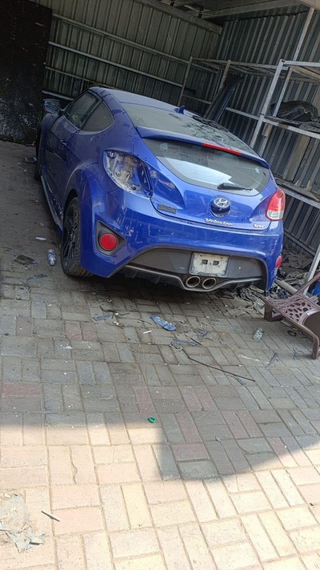 Blue Hyundai Veloster Turbo rear — tailgate, rear bumper, taillights and alloy wheel, Sharjah market