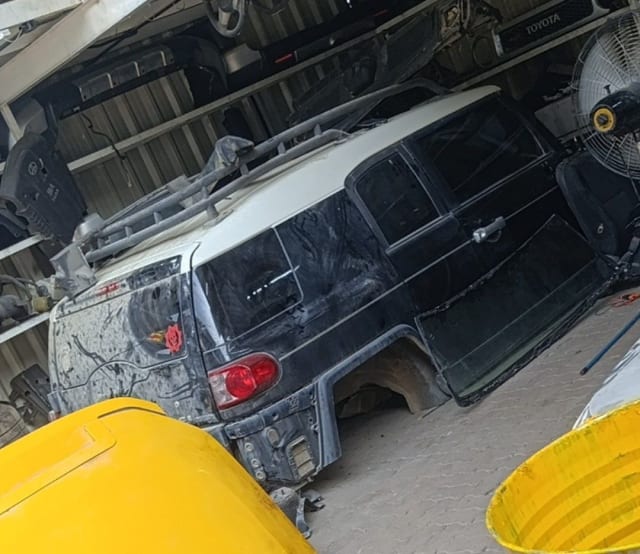 Black Toyota FJ Cruiser rear halfcut with white roof — tailgate, rear door and tail light, Sharjah market