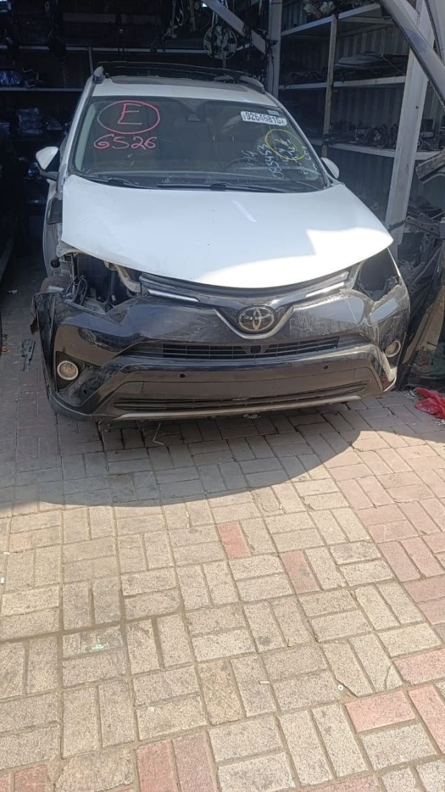 White Toyota RAV4 SUV front cut — hood, grille, bumper and headlight, Sharjah market