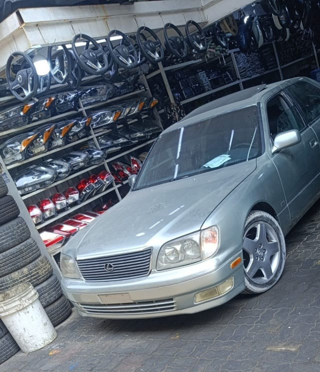 Silver Lexus LS400 sedan for parts — grille, headlights, front bumper and alloy wheels, Sharjah market