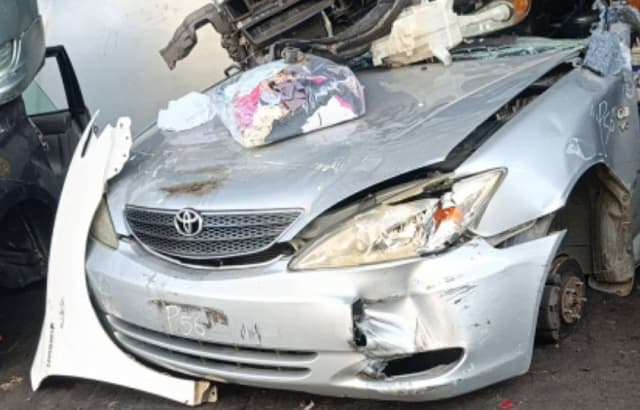 Silver Toyota Camry sedan front halfcut — grille, hood, headlights and bumper with front damage, Sharjah market