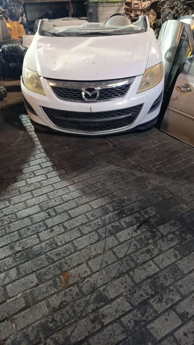 White Mazda CX-9 SUV front halfcut — bumper, grille and headlights, Sharjah market