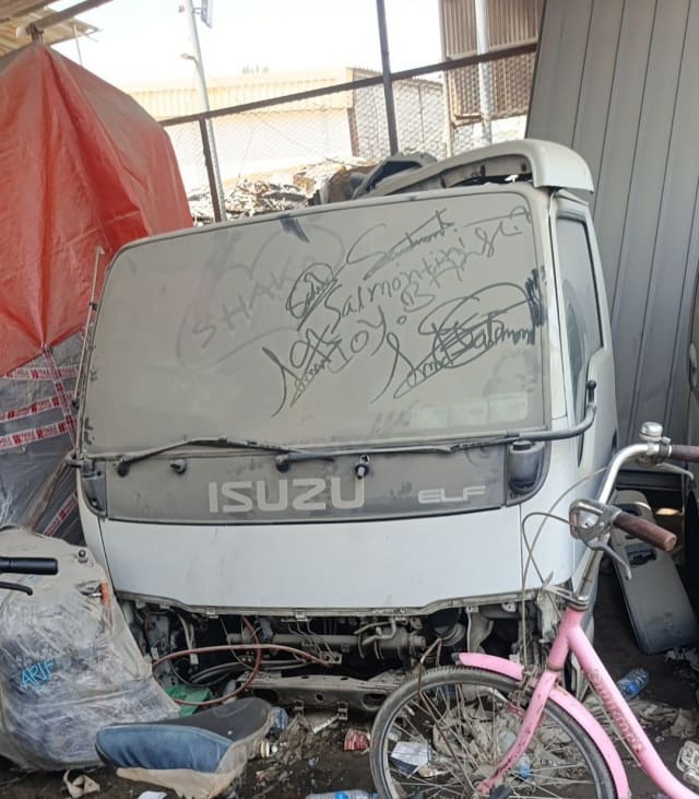 White Isuzu Elf cab-over truck halfcut — front cabin, windscreen and ISUZU ELF fascia, Sharjah market
