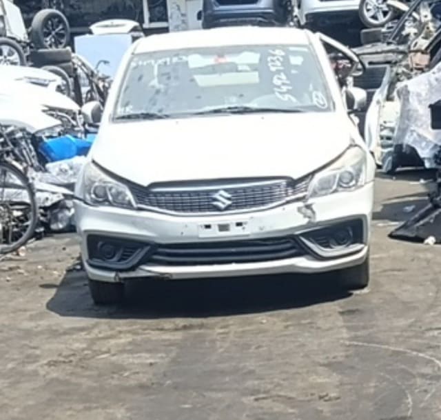 White Suzuki Ciaz sedan front end — bumper, chrome grille and headlights, Sharjah market