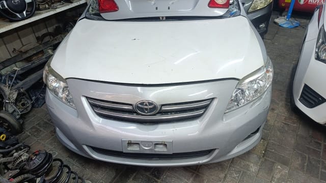 Silver Toyota Corolla sedan front halfcut — bumper, grille, headlights and hood, Sharjah market