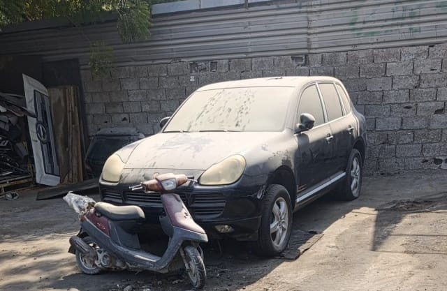 Black Porsche Cayenne SUV for parts — front bumper, grille, headlights and hood, Sharjah market