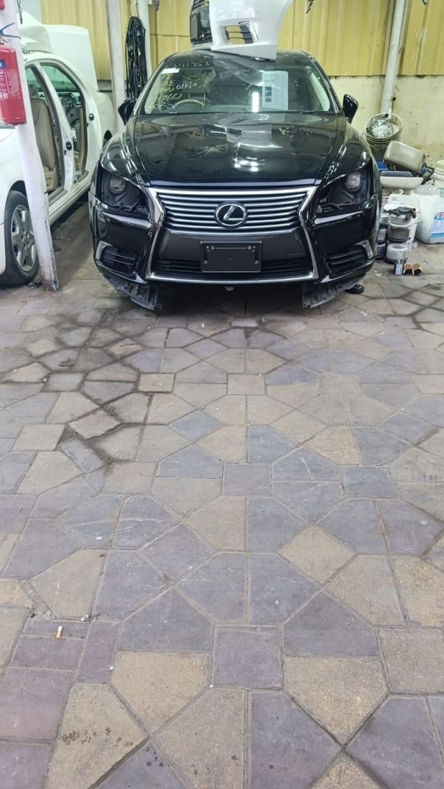 Black Lexus LS460 sedan front cut — grille, headlights and bumper, Sharjah market