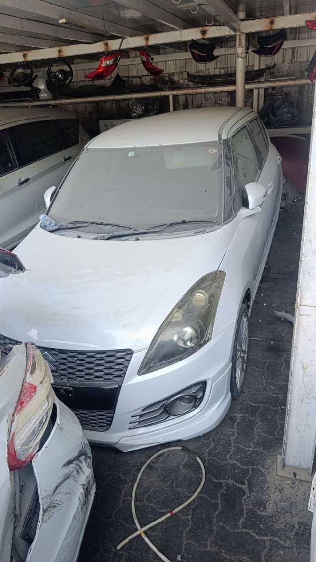 White Suzuki Swift hatchback front — grille, headlights, bumper and hood, Sharjah market
