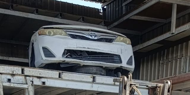 White Toyota Camry sedan front halfcut — bumper, grille and headlights, Sharjah market