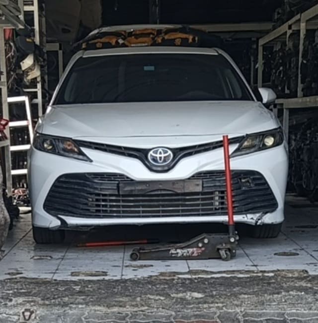 White Toyota Camry sedan front — bumper, grille, headlights and hood, Sharjah market