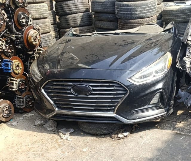 Black Hyundai Sonata sedan front halfcut — bumper, chrome grille, headlights and hood, Sharjah market