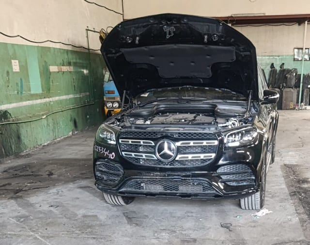 Black Mercedes-Benz GLS SUV front with open hood — bumper, grille, headlights and engine bay, Sharjah market