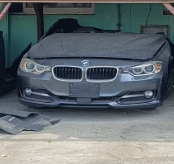 Dark grey BMW 3-Series sedan halfcut — front bumper, kidney grille and headlights, Sharjah market