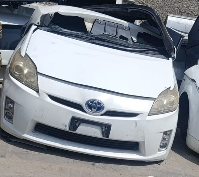 White Toyota Prius hatchback front halfcut — bumper, grille, headlights and hood, Sharjah market