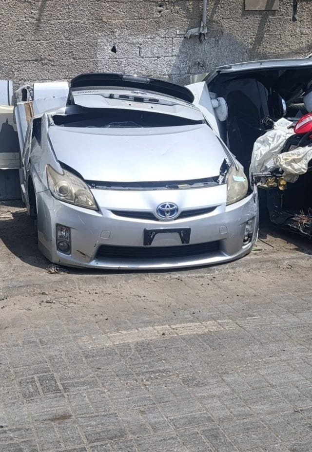 Silver Toyota Prius hatchback front halfcut — bumper, grille and headlights, Sharjah market