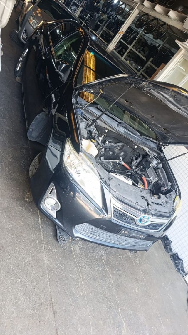 Black Toyota Camry Hybrid front cut — bumper, grille, headlight and open engine bay, Sharjah market