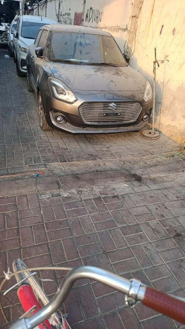 Dark grey Suzuki Swift hatchback front — bumper, grille, headlights and hood, Sharjah market