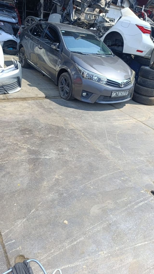 Dark grey Toyota Corolla sedan front — bumper, grille, headlights and hood, Sharjah market