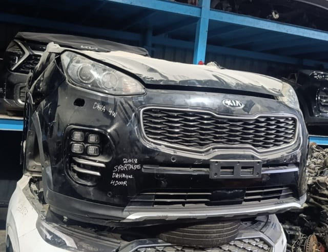 Black Kia Sportage front halfcut with grille, headlight and LED fog lights, Sharjah market