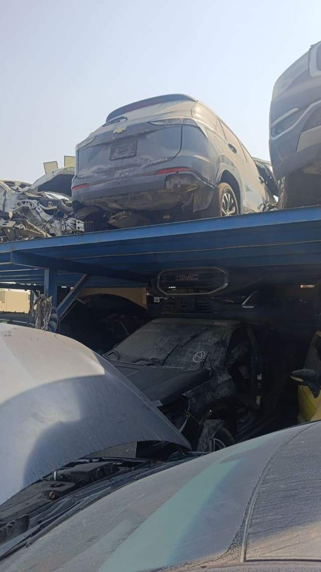Grey Chevrolet Groove SUV for parts, rear view with tailgate and taillights on a rack, Sharjah market