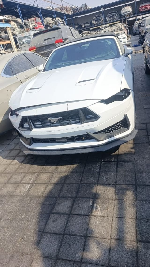 White Ford Mustang convertible for parts: vented hood, pony grille and bumper, headlights missing, Sharjah