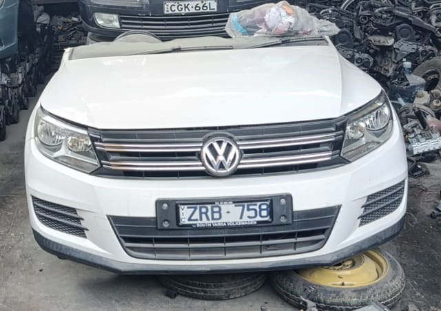 White Volkswagen Tiguan front halfcut: hood, chrome grille, headlights and bumper, Sharjah market