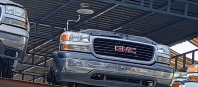Dark blue GMC Sierra front halfcut — chrome bumper, GMC grille and headlights, Sharjah market