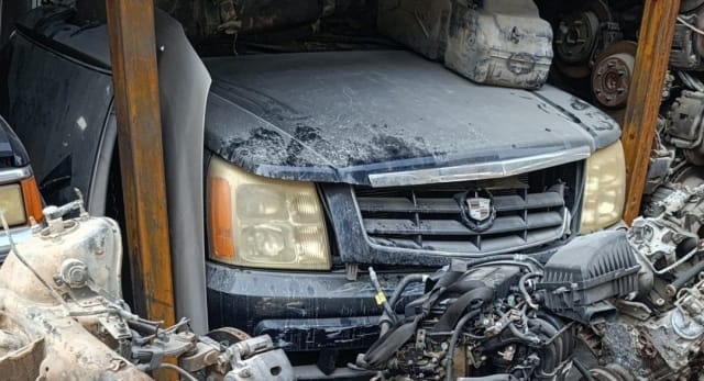 Black Cadillac Escalade front halfcut with hood, grille and headlights, loose engine in front, Sharjah market