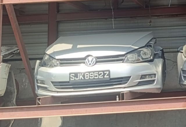 Silver Volkswagen Golf front halfcut on rack — hood, bumper, grille and headlights, Sharjah market