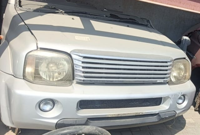 Silver Suzuki Jimny halfcut front — chrome grille, headlights, bumper and fog lights, Sharjah market