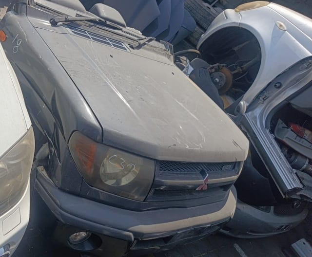 Dark grey Mitsubishi Pajero iO front halfcut — hood, grille, headlight and bumper, Sharjah market