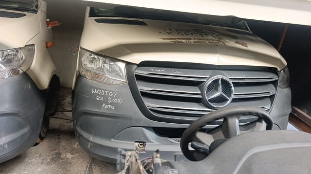Beige Mercedes-Benz Sprinter van front halfcut — hood, chrome grille, headlights and grey bumper, Sharjah market