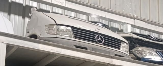 White Mercedes-Benz Vito front halfcut on a shelf — hood, grille, headlights and bumper, Sharjah market