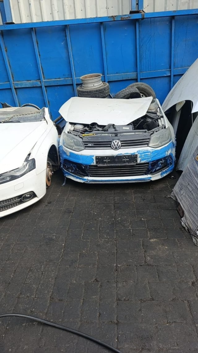 White Volkswagen Polo front halfcut: hood, R-Line grille, headlights and taped bumper, Sharjah market