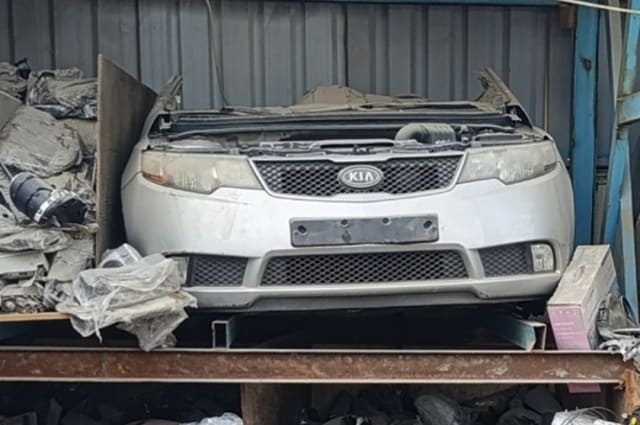 Silver Kia Cerato front halfcut: bumper, grille and headlights, hood removed, Sharjah market