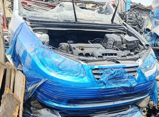 Silver Hyundai Elantra front halfcut, open hood, engine, film-wrapped bumper and grille, Sharjah market